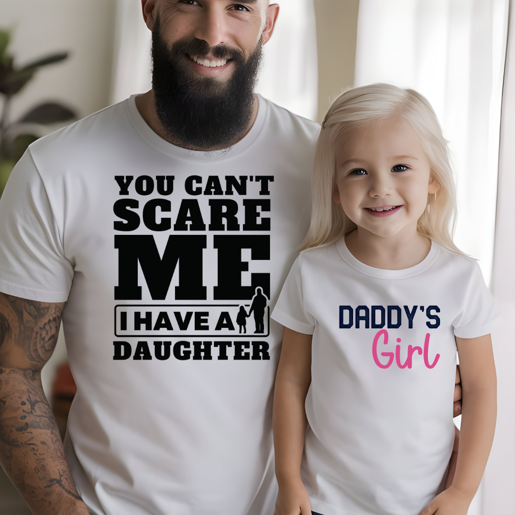 Father and daughter wearing matching "Girl Dad" shirts, showcasing family bond and style.